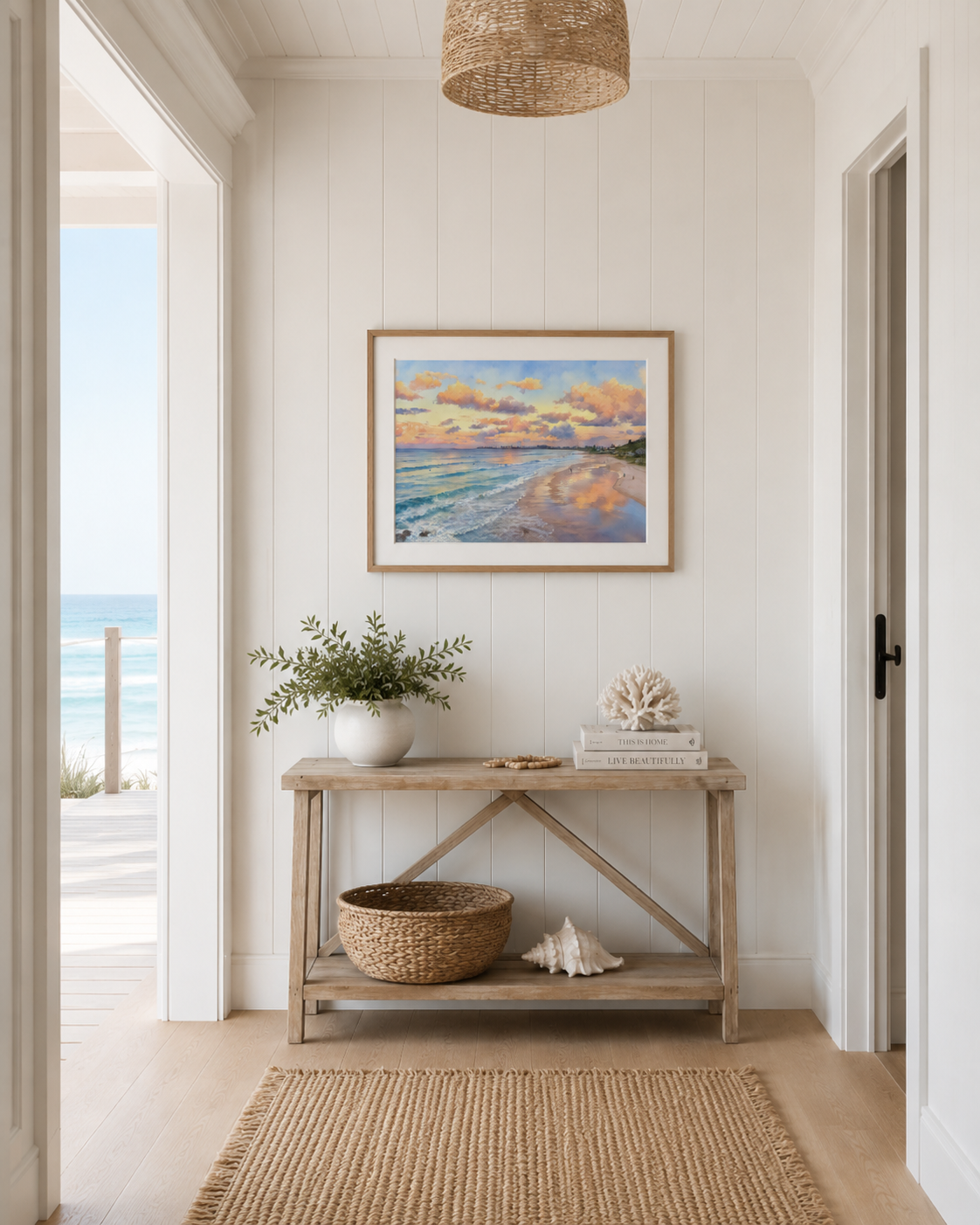 Framed Currumbin Beach watercolour print displayed above a console table in a coastal hallway
